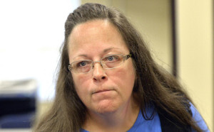 Rowan County Clerk Kim Davis listens to a customer following her office's refusal to issue marriage licenses at the Rowan County Courthouse in Morehead, Ky., Tuesday, Sept. 1, 2015. Although her appeal to the U.S. Supreme Court was denied, Davis still refuses to issue marriage licenses. (AP Photo/Timothy D. Easley)